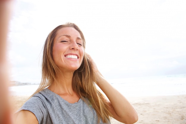 Premium Photo Beautiful Young Woman Taking Selfie At The Beach With Hand In Hair