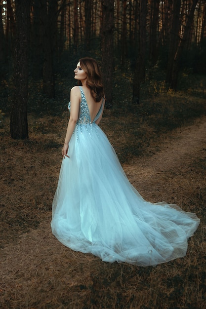 Premium Photo | Beautiful young woman wearing white dress in the forest