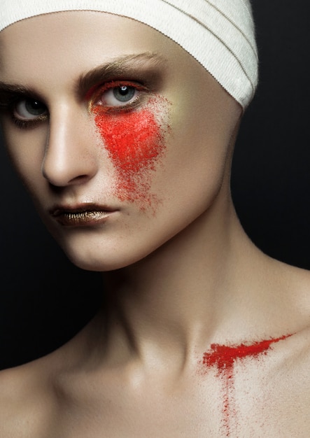 Beauty woman bandage plastic surgery red powder make up on black wall Premium Photo
