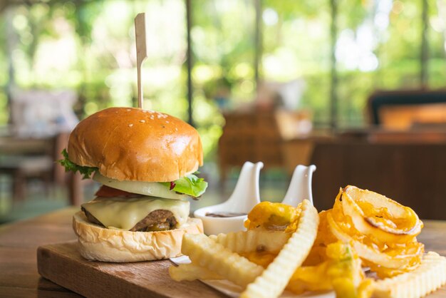 Premium Photo | Beef burger with cheese and potato chips on wood tray