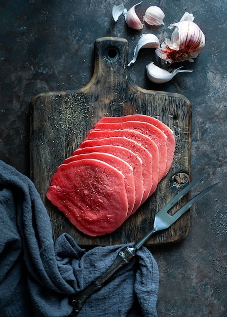 Premium Photo | Beef raw meat thin slices on dark