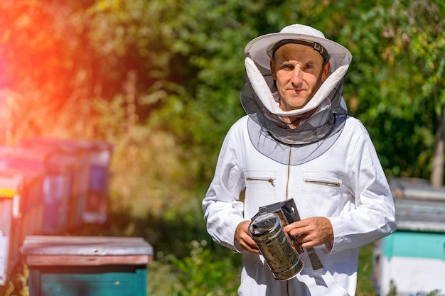 Premium Photo | Beekeeper standing with equipment. man in protective ...