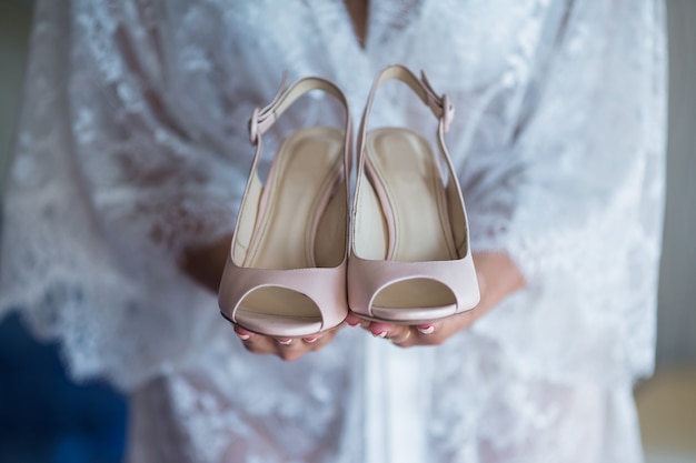 Premium Photo | Beige wedding shoes on the gatherings of the bride
