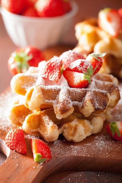 Premium Photo | Belgian waffles with icing sugar and strawberry