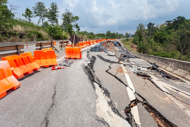 Big damage of asphalt road on the hillside cause of heavy rain and sliding earth Premium Photo