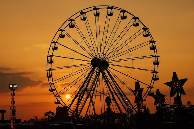 Big Ferris Wheel Swing At Amusement Park In Silhouette