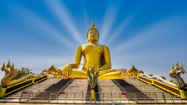 Premium Photo | Big golden buddha statues with serpent at front in ang ...