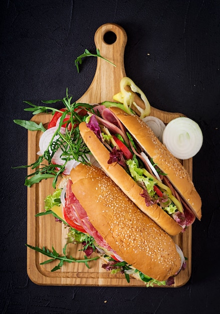 Premium Photo | Big sandwich with ham, salami, tomato, cucumber and herbs