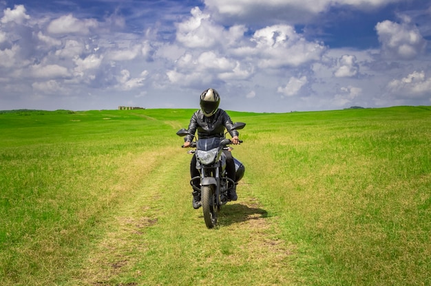 Premium Photo | Biker man on a country road, young man on his ...