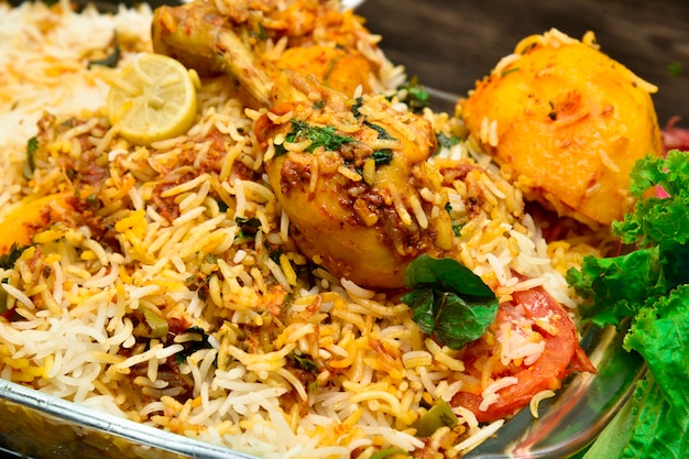 Premium Photo | Biryani with chicken potatoes any many other spices