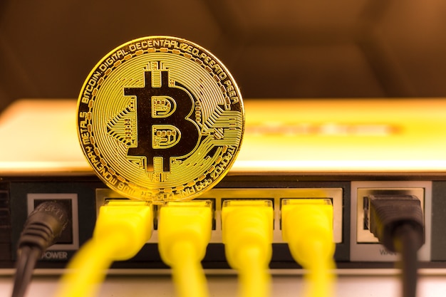 Bitcoin coin on the back of a router Premium Photo