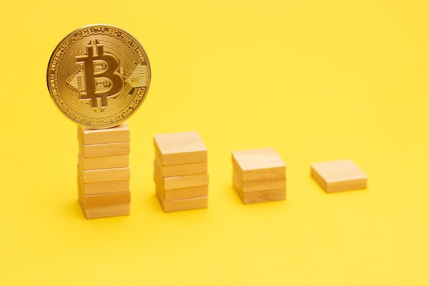 Premium Photo | Bitcoin golden coin on a ladder from wooden blocks.