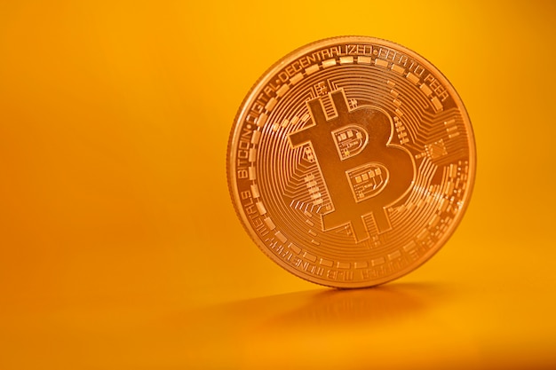 Bitcoin. virtual money.gold bitcoin coin on a gold matte background. cryptocurrency Premium Photo