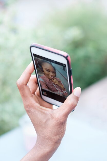 Premium Photo | Black afro girl's hand holding smartphone and making selfie