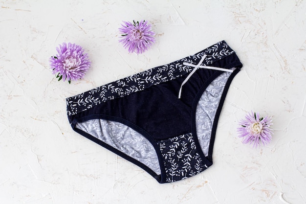 Premium Photo | Black cotton panties with flower buds on the white ...