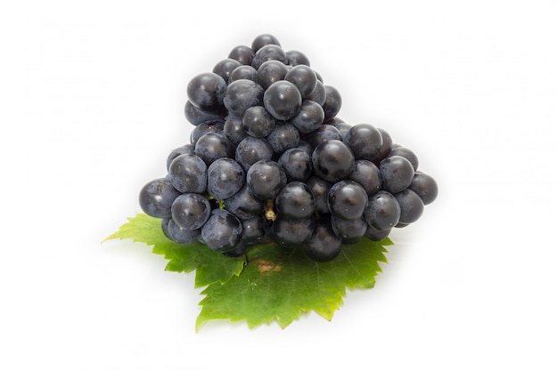 Black grapes bunch isolated on white background with green leaf package design element Premium Photo