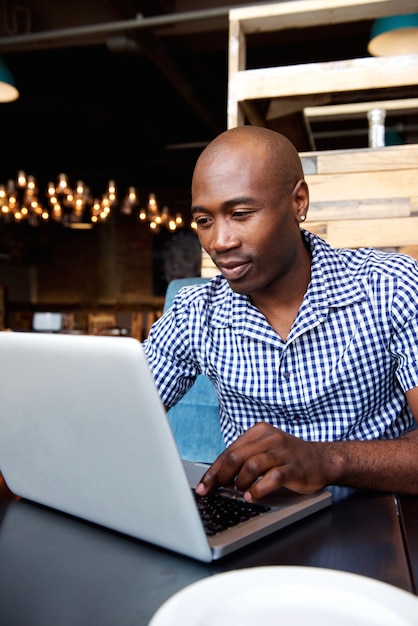 Premium Photo | Black guy working on laptop at a cafe