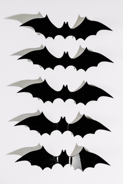 Free Photo | Black halloween plastic bats in line