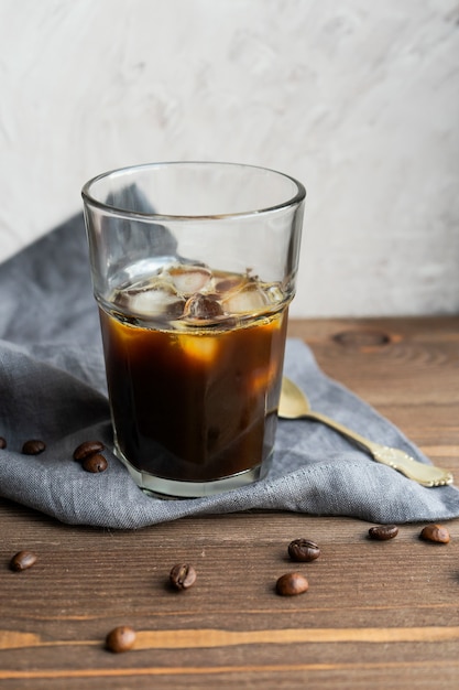 Premium Photo | Black iced coffee on wooden