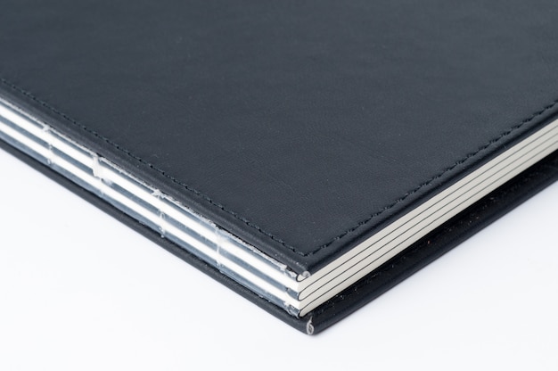 Premium Photo | Black notebook on white background.