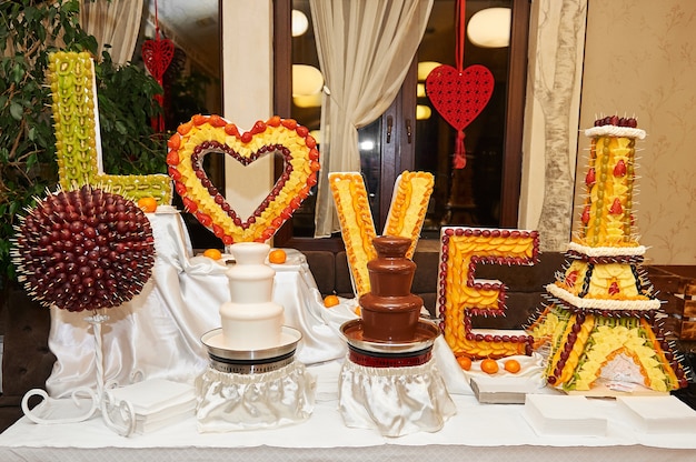 Black And White Chocolate Fountains On The Table At The Restaurant