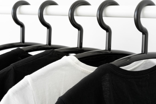 Black And White Color Tone Clothes On Hangers In Wardrobe Woman