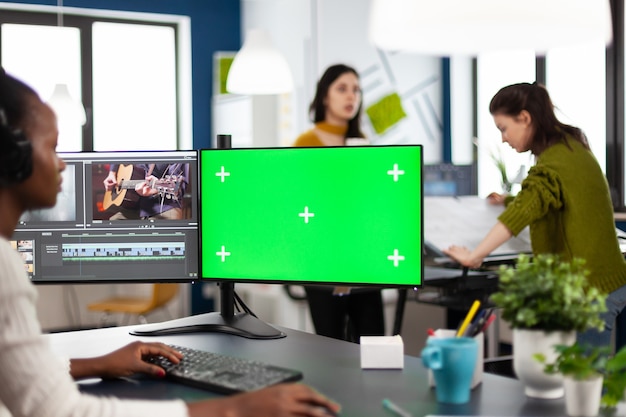 Premium Photo Black Woman Videographer Employee With Headphones Using Computer With Green Screen Chroma Key Mockup Isolated Display Sitting In Video Production Studio