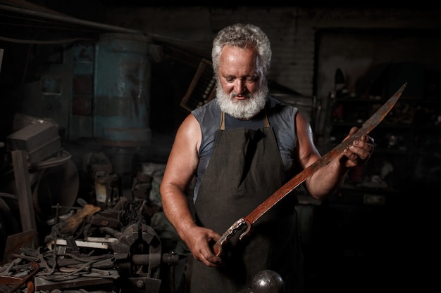 Premium Photo | Blacksmith preparing to work metal on anvil