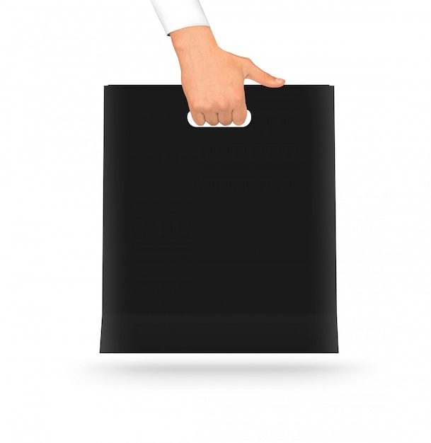 Download Blank black paper bag mock up holding in hand. | Premium Photo
