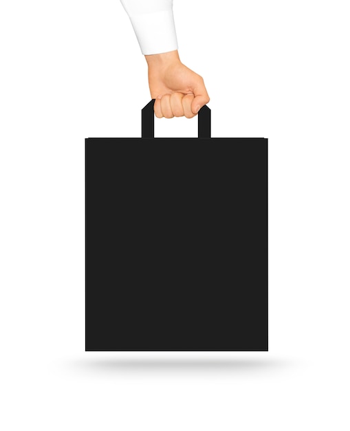 Blank black paper bag mock up holding in hand. Photo ...