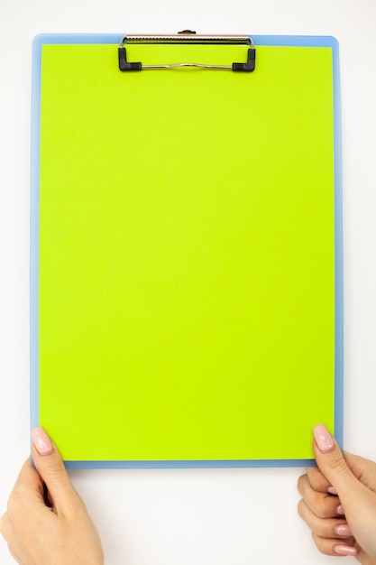 Premium Photo | Blank folder with green paper, hand that holding folder ...