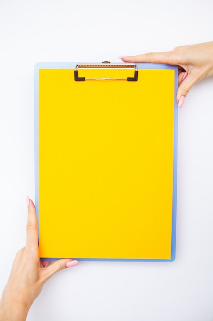 Premium Photo | Blank folder with yellow paper, hand that holding ...