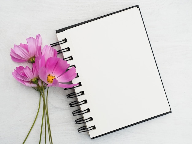 Premium Photo | Blank notepad page and a beautiful flower