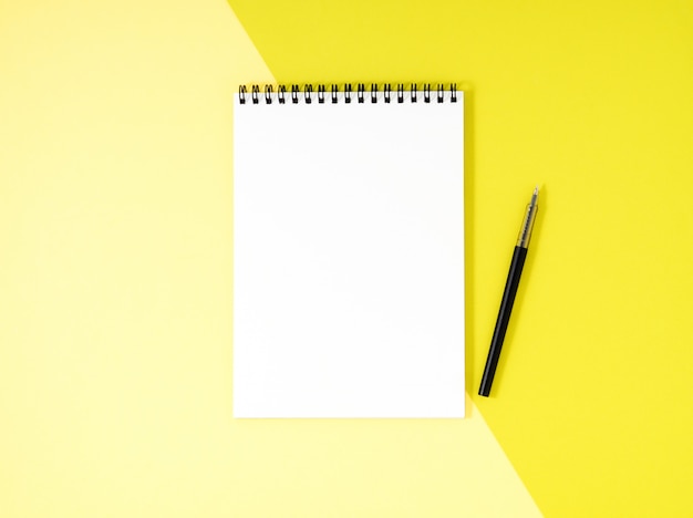 Premium Photo | Blank notepad white page on yellow desk, color ...