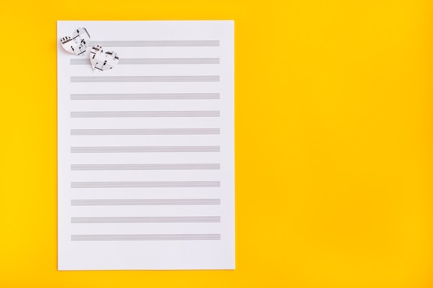 Premium Photo Blank Sheet Music And Hearts Cut From Music Text On Yellow Surface Top View