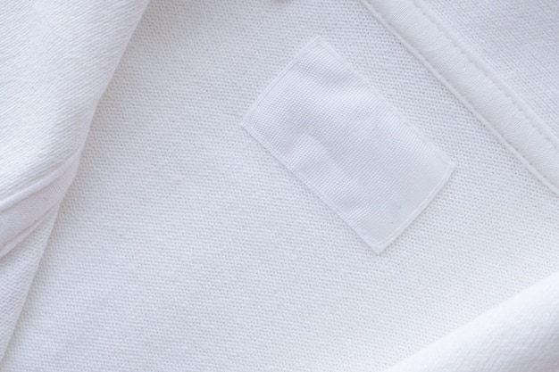 Premium Photo | Blank white clothes label on new shirt background