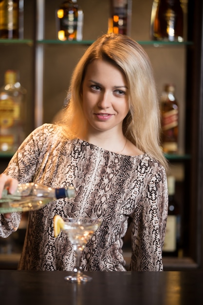 Blond bartender making cocktail Photo | Free Download