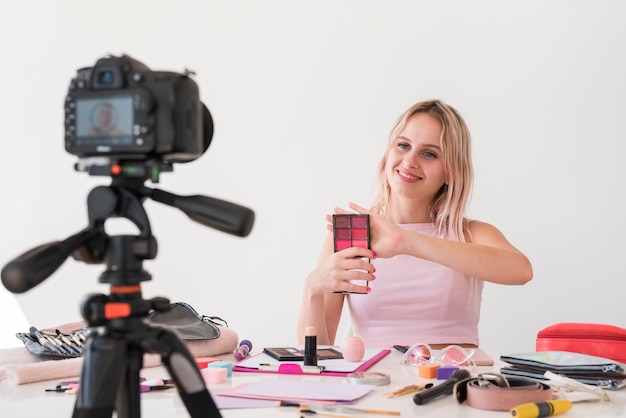 Blonde influencer recording make up video Free Photo