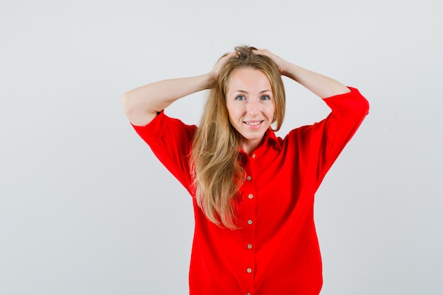 Free Photo | Blonde woman clasping head with hands in red shirt and ...