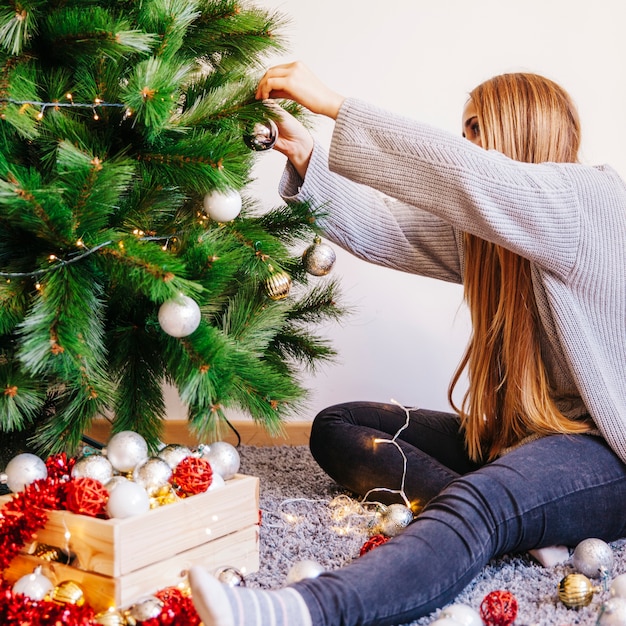 Free Photo | Blonde woman decorating christmas tree