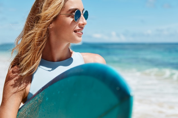 Free Photo Blonde Woman With Surfboard On Beach