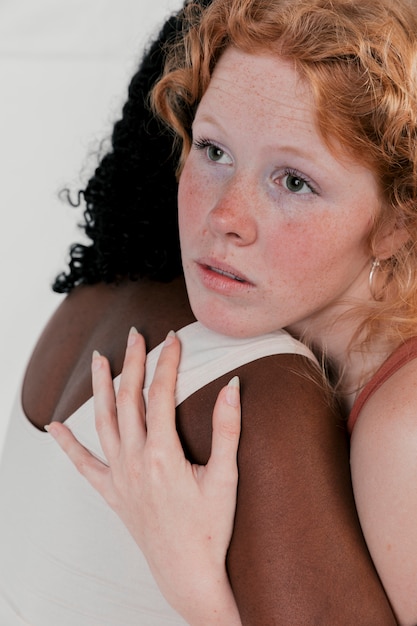 Blonde Young Woman Hugging Her African Friend With Dark Skinned