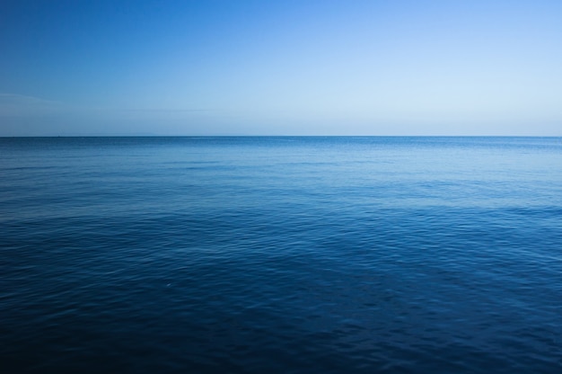 Premium Photo | Blue dark and deep ocean, horizontal seascape with blue sky