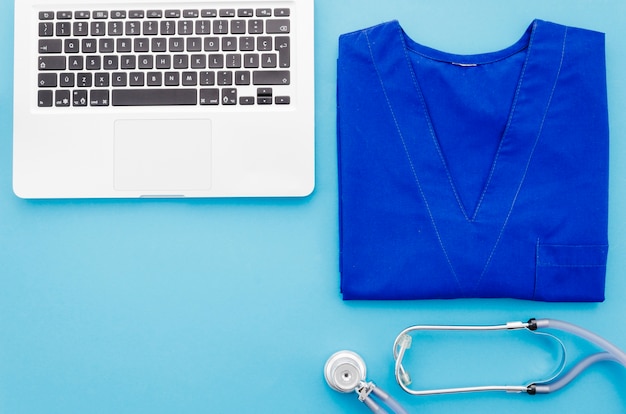 Free Photo | Blue doctor coat; stethoscope and laptop on blue background