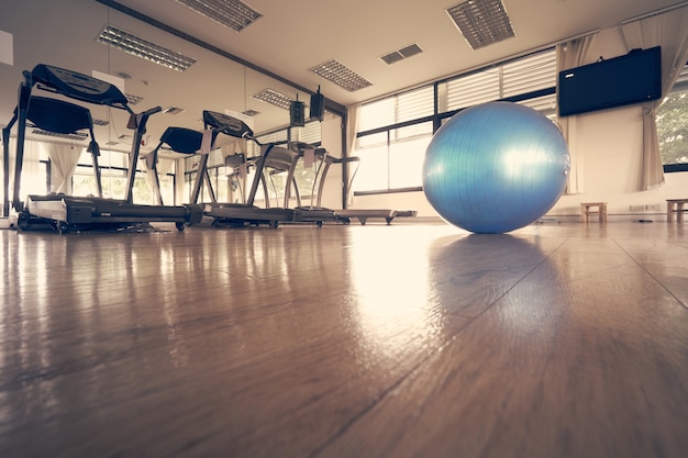 Premium Photo | The blue exercise ball placed in the center of the ...