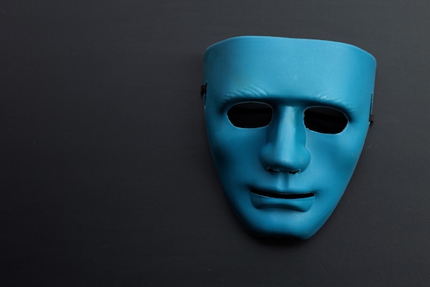 Premium Photo  Blue face mask on dark surface. copy space