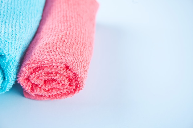 Blue and pink towel spa cloth beach towels on blue background. Premium Photo