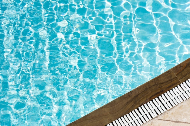 Premium Photo | Blue pool water with sun reflections