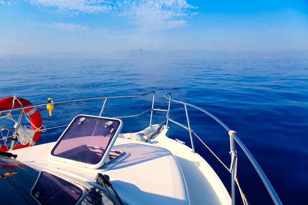 Premium Photo | Blue sea boat sailing with open bow porthole