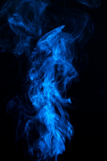 Blue smoke on the center of the black background Photo | Free Download